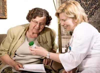 Nurse and senior reviewing medications