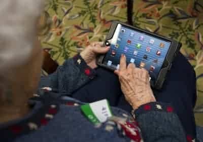 Senior using touch screen on iPad