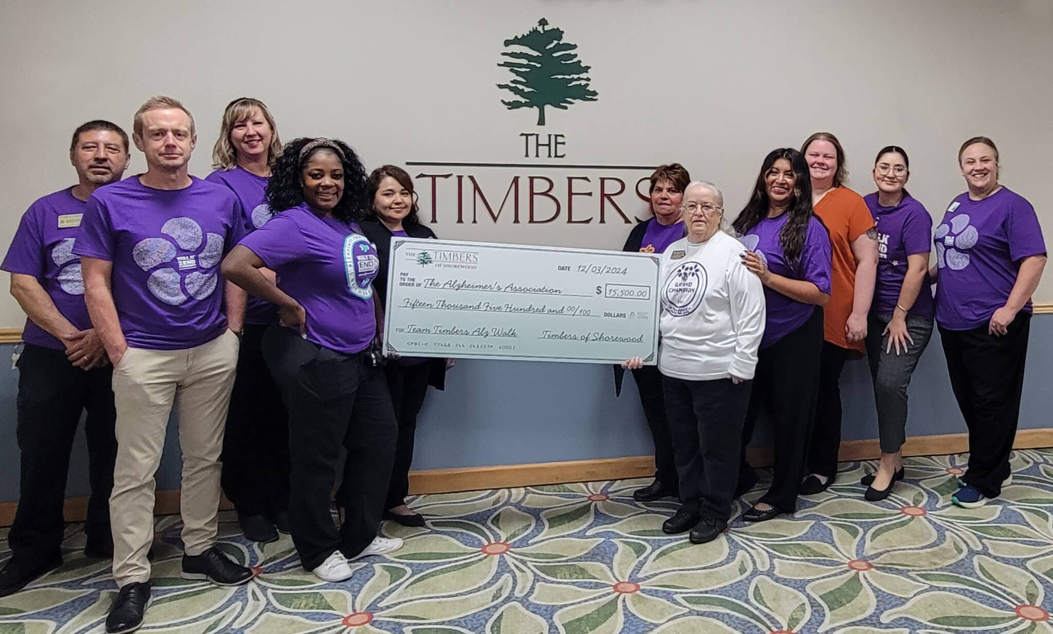 Timbers of Shorewood staff holding a check to donate to Alzheimer's Association